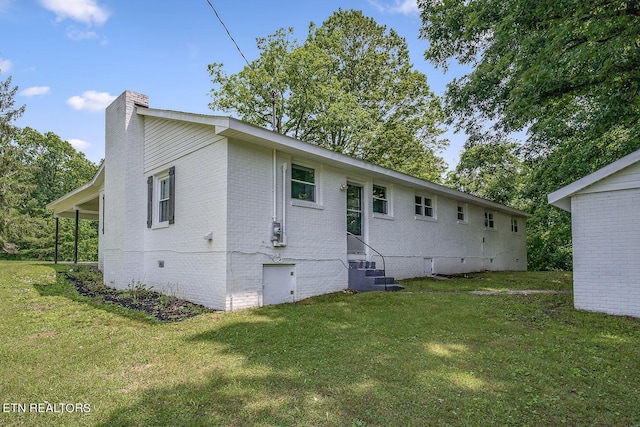 rear view of house featuring a yard