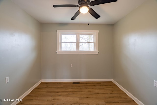 empty room with ceiling fan and hardwood / wood-style floors