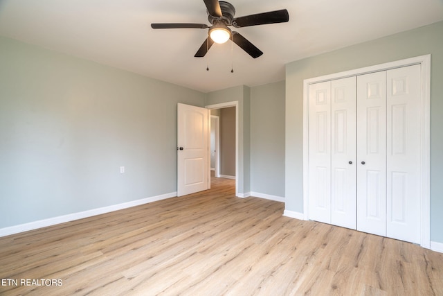 unfurnished bedroom featuring ceiling fan, a closet, and light hardwood / wood-style floors