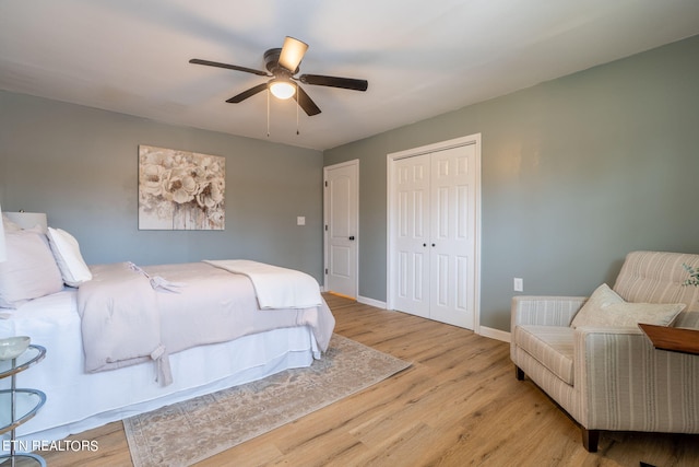 bedroom featuring ceiling fan, a closet, and light hardwood / wood-style floors