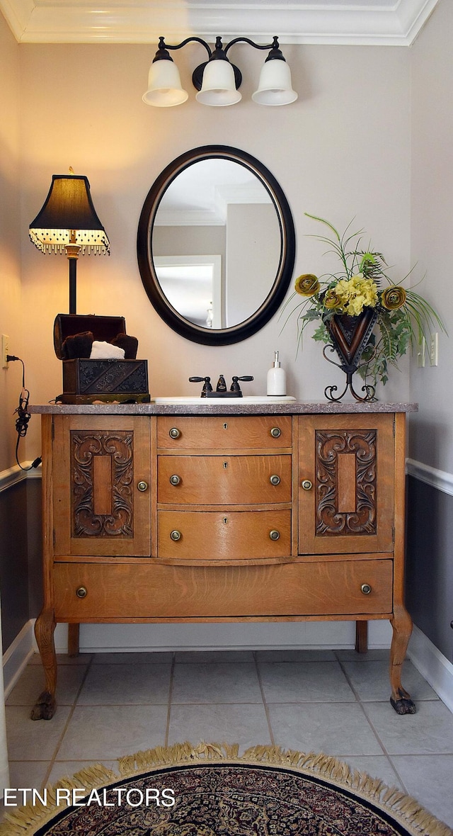 bathroom featuring crown molding, tile patterned floors, and vanity