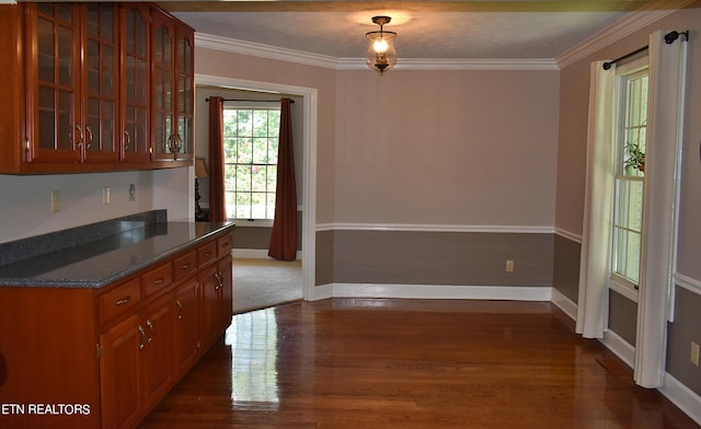 kitchen with dark hardwood / wood-style flooring and crown molding