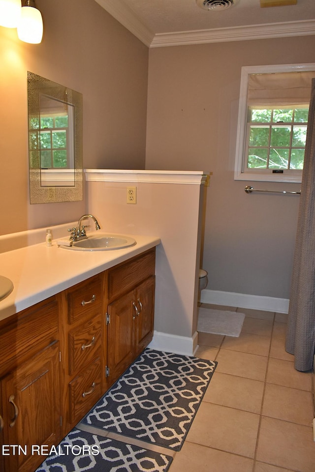 bathroom with ornamental molding, tile patterned flooring, and vanity