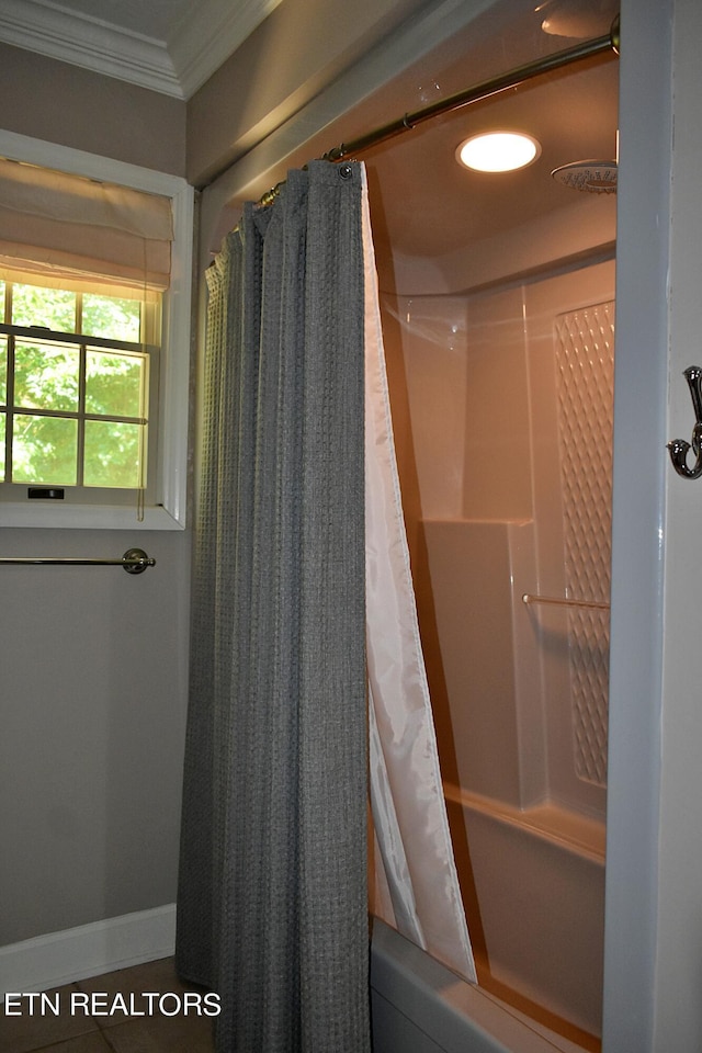 bathroom featuring shower / bath combination with curtain and ornamental molding