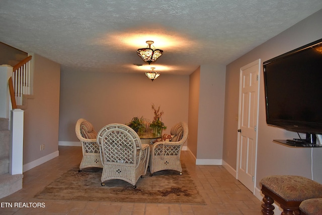 dining area with a textured ceiling