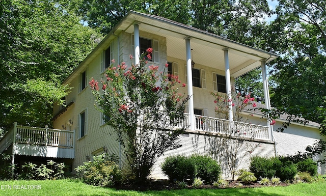 view of side of home featuring covered porch