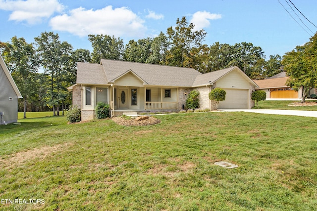 ranch-style house featuring covered porch, a front yard, and a garage