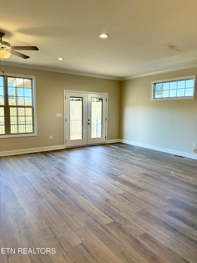 unfurnished room with french doors, crown molding, ceiling fan, and light hardwood / wood-style flooring