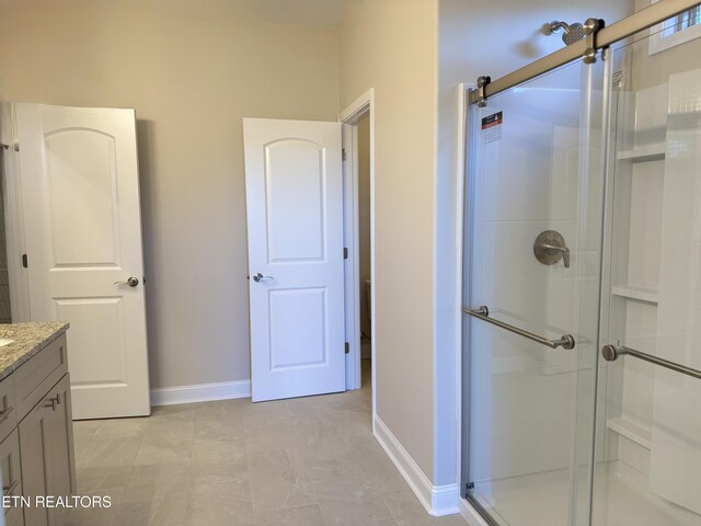 bathroom featuring vanity and a shower with shower door