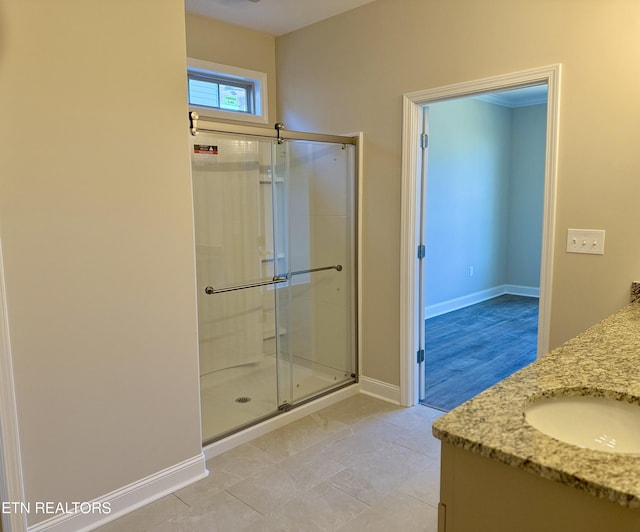 bathroom featuring an enclosed shower and vanity