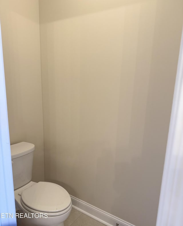 bathroom featuring tile patterned flooring and toilet