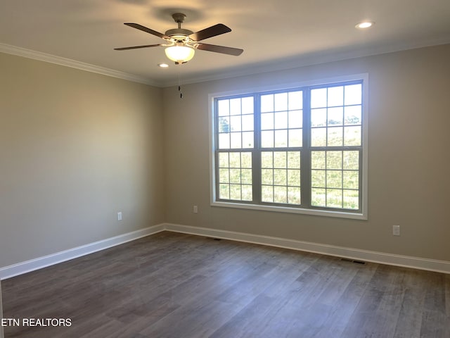 spare room with ornamental molding, dark wood-type flooring, and ceiling fan