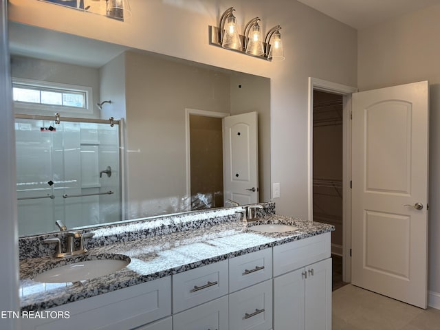 bathroom with vanity and a shower with shower door