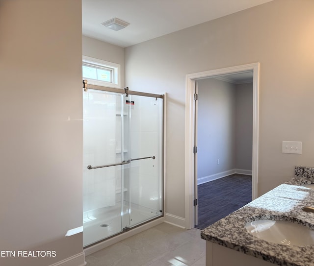 bathroom with vanity and a shower with door