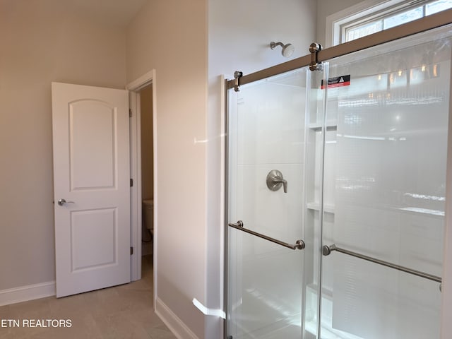 bathroom with tile patterned floors and walk in shower