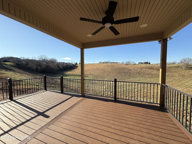 wooden terrace featuring a rural view and ceiling fan