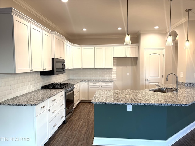 kitchen featuring stainless steel gas range oven, white cabinets, decorative light fixtures, dark hardwood / wood-style flooring, and sink