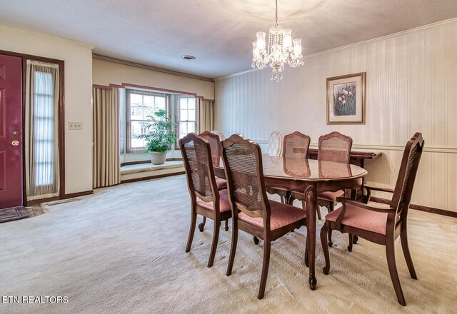 carpeted dining room featuring crown molding, a chandelier, and a textured ceiling