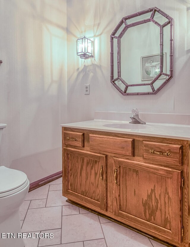 bathroom with tile patterned floors, vanity, and toilet