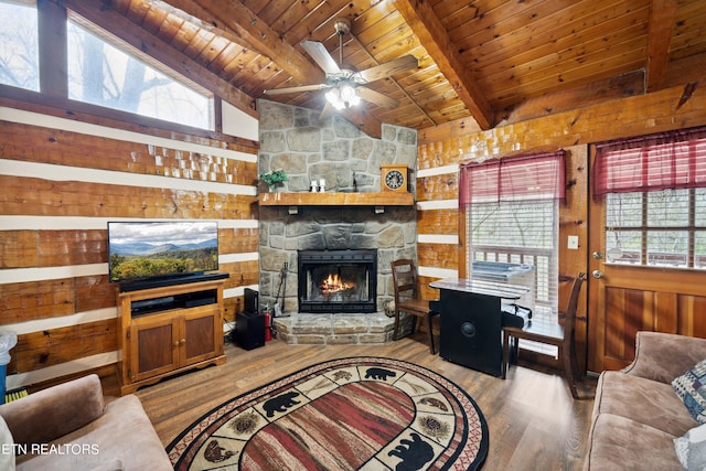 living room featuring light hardwood / wood-style floors, wooden walls, and wood ceiling