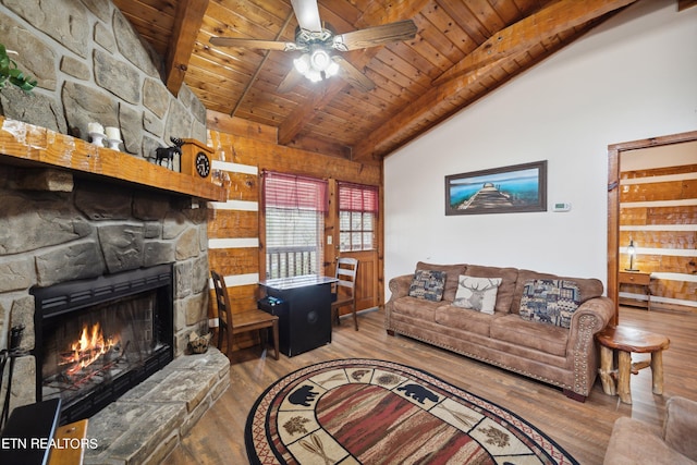 living room with ceiling fan, dark wood-type flooring, wooden walls, wood ceiling, and a fireplace