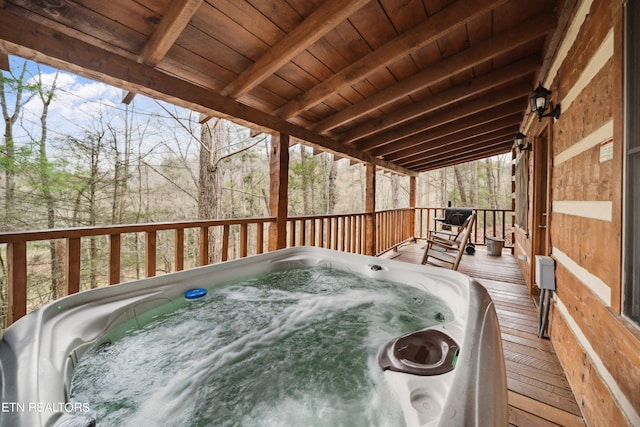 wooden deck featuring an outdoor hot tub