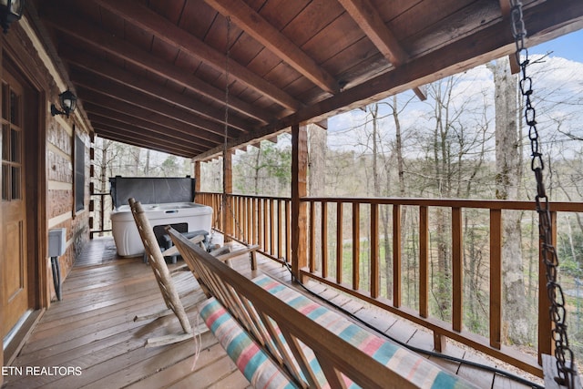 wooden terrace with a hot tub