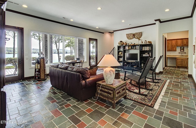 living room with sink and ornamental molding