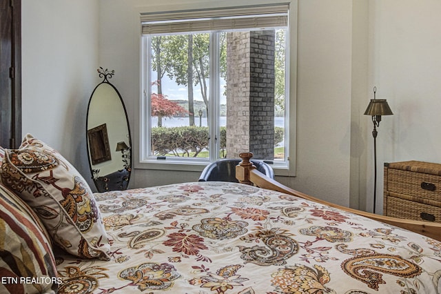 bedroom featuring a water view