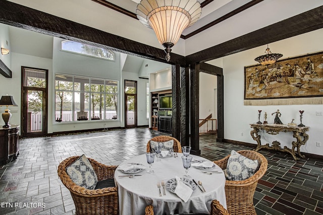 dining area with a notable chandelier and a high ceiling