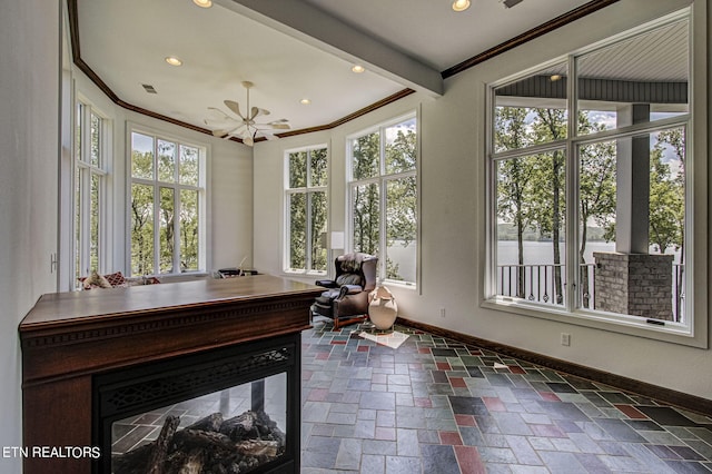 home office featuring beamed ceiling, ceiling fan, and ornamental molding