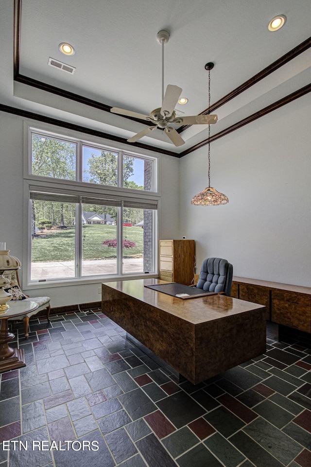 unfurnished office featuring ceiling fan, ornamental molding, and a tray ceiling