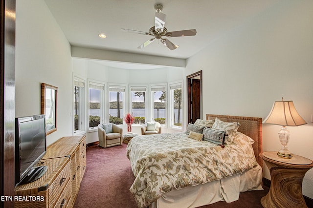 bedroom featuring dark carpet and ceiling fan