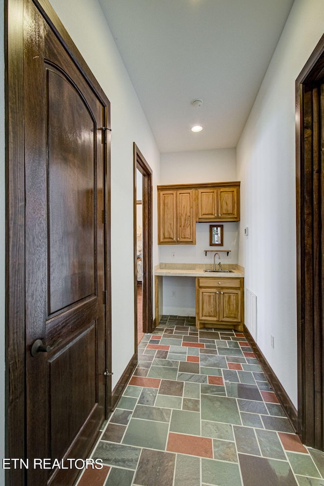 kitchen featuring sink and built in desk