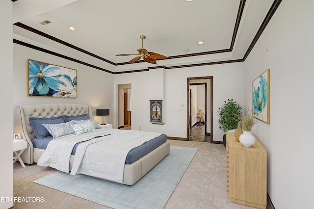 carpeted bedroom with ceiling fan and ornamental molding