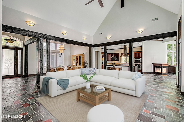 living room with high vaulted ceiling, a wealth of natural light, and ceiling fan