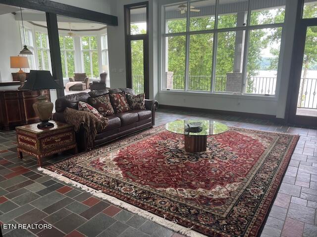 sunroom featuring ceiling fan