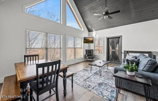 interior space featuring wooden ceiling, high vaulted ceiling, light hardwood / wood-style flooring, and ceiling fan