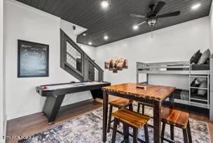 dining room with ceiling fan and dark wood-type flooring