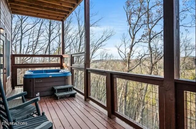 wooden terrace with a hot tub