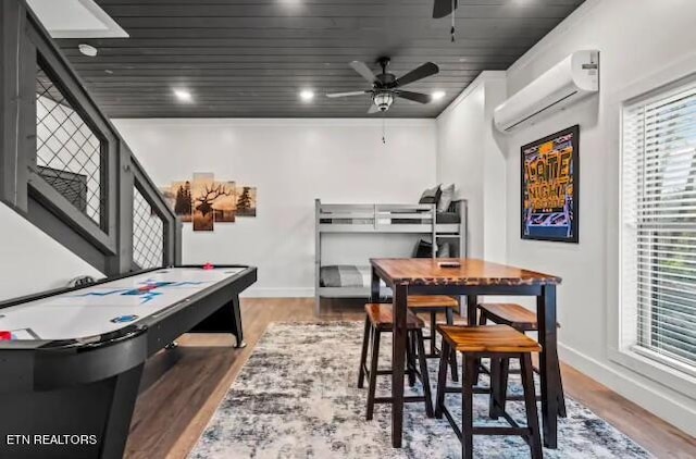 rec room featuring an AC wall unit, wood ceiling, dark hardwood / wood-style floors, and ceiling fan