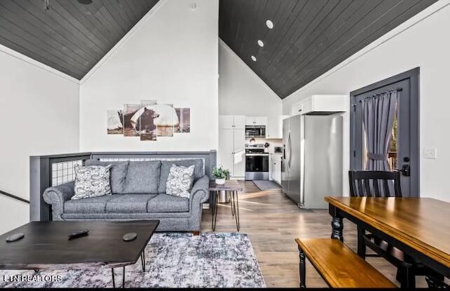 living room with light hardwood / wood-style flooring, high vaulted ceiling, wood ceiling, and crown molding