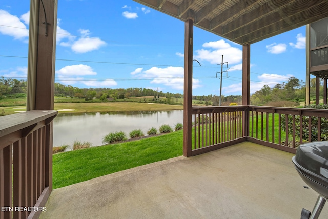 view of terrace featuring a water view and area for grilling