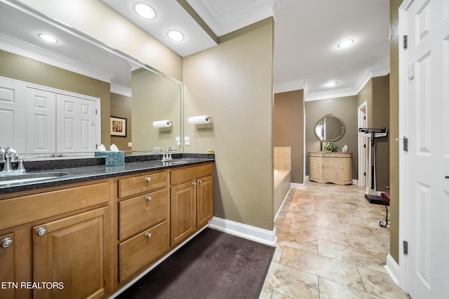 bathroom with vanity with extensive cabinet space, ornamental molding, a bathing tub, tile flooring, and dual sinks