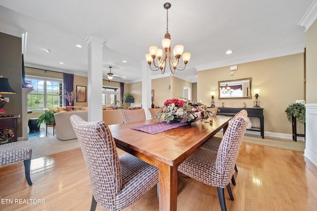 dining space with ceiling fan with notable chandelier, crown molding, light hardwood / wood-style flooring, and decorative columns