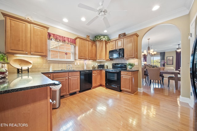 kitchen with backsplash, ceiling fan with notable chandelier, black appliances, and light wood-type flooring