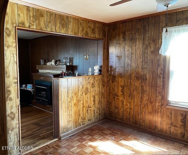 bar featuring ceiling fan, wooden walls, and parquet floors