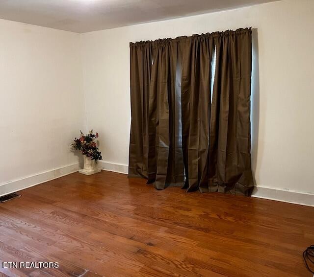 unfurnished room with hardwood / wood-style flooring