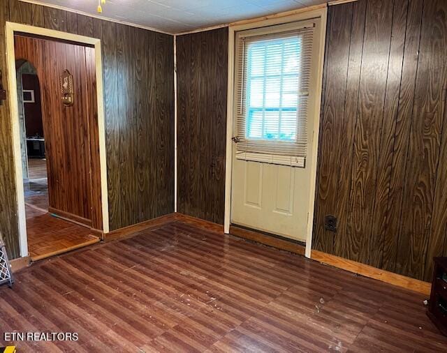 interior space with wood walls and wood-type flooring