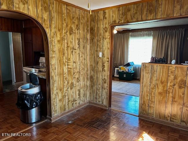 interior space featuring wooden walls and parquet flooring